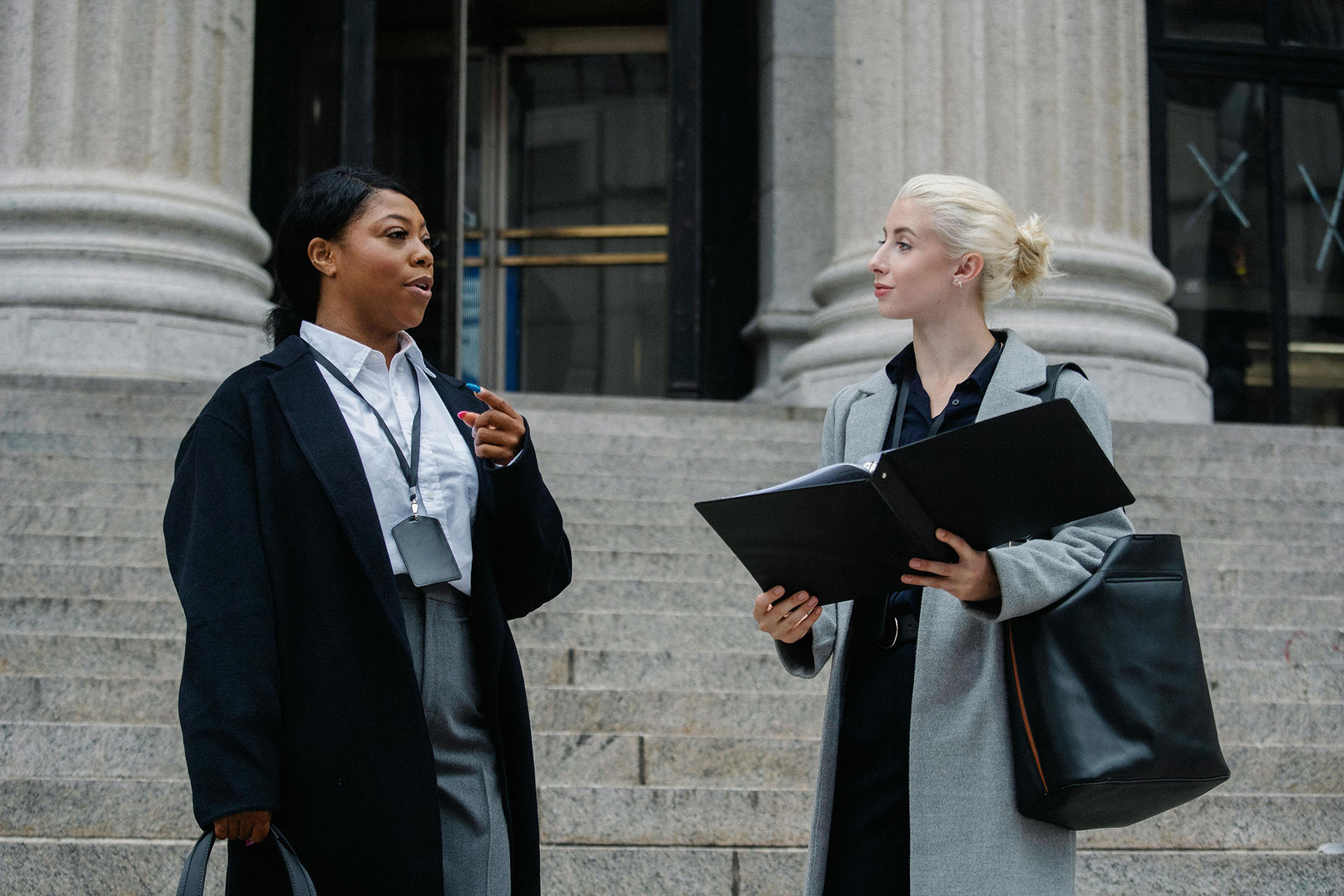 Two women standing outside a courthouse