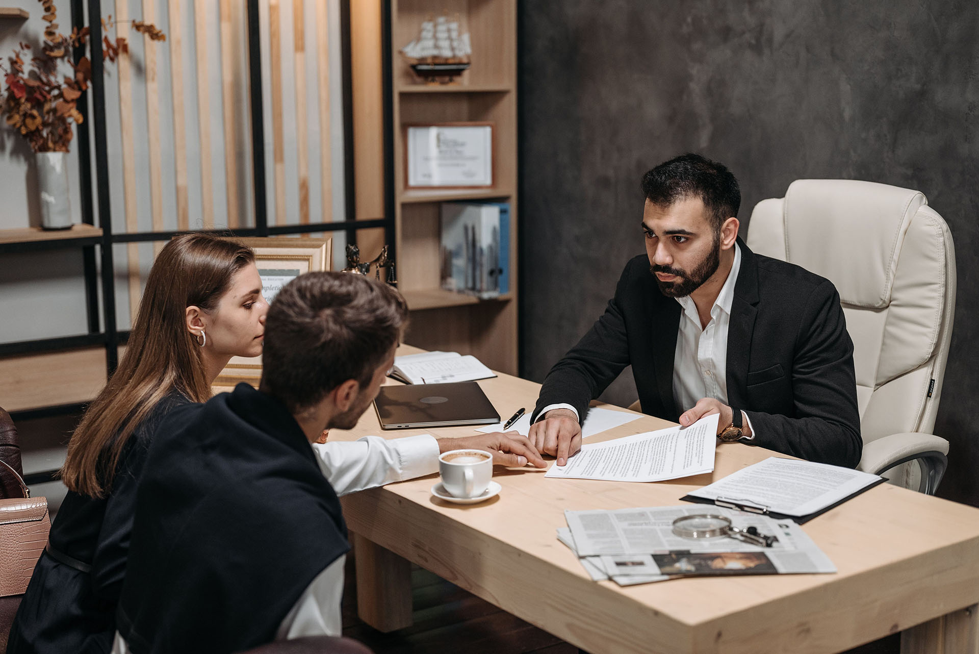 Man having a discussion with a couple in his office