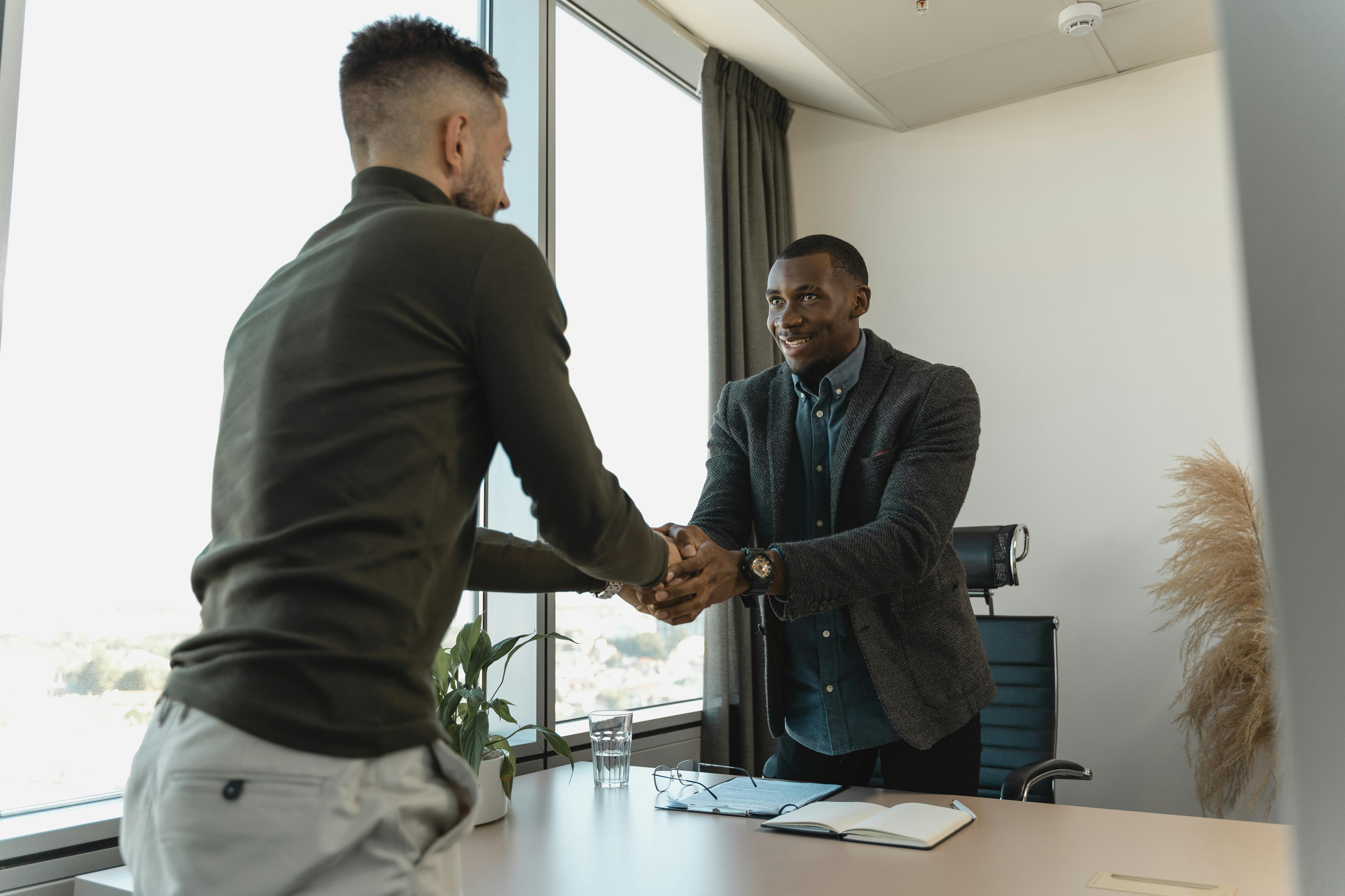 Man if an office shaking hands with a client