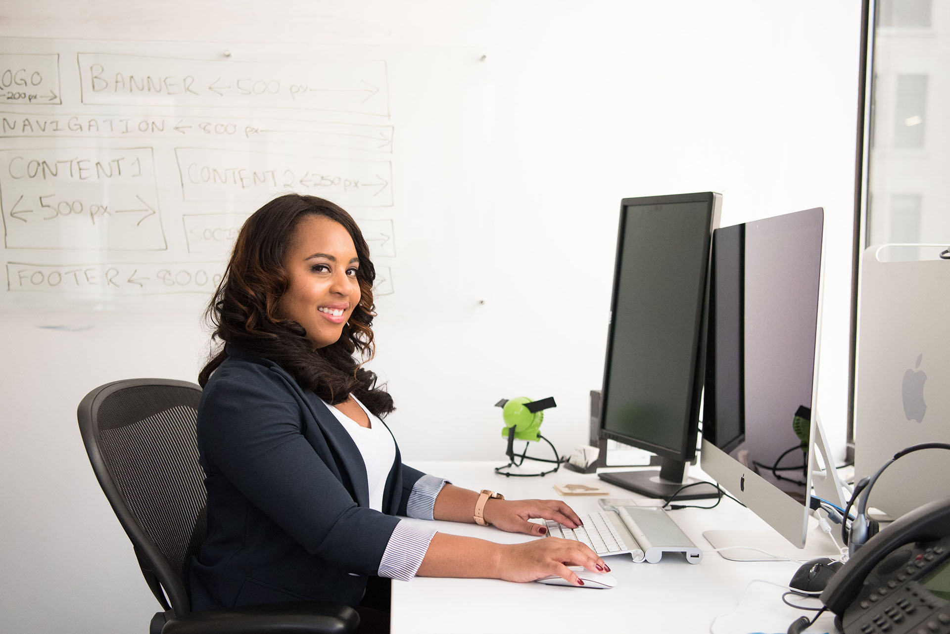 Female sitting at a desk smiling