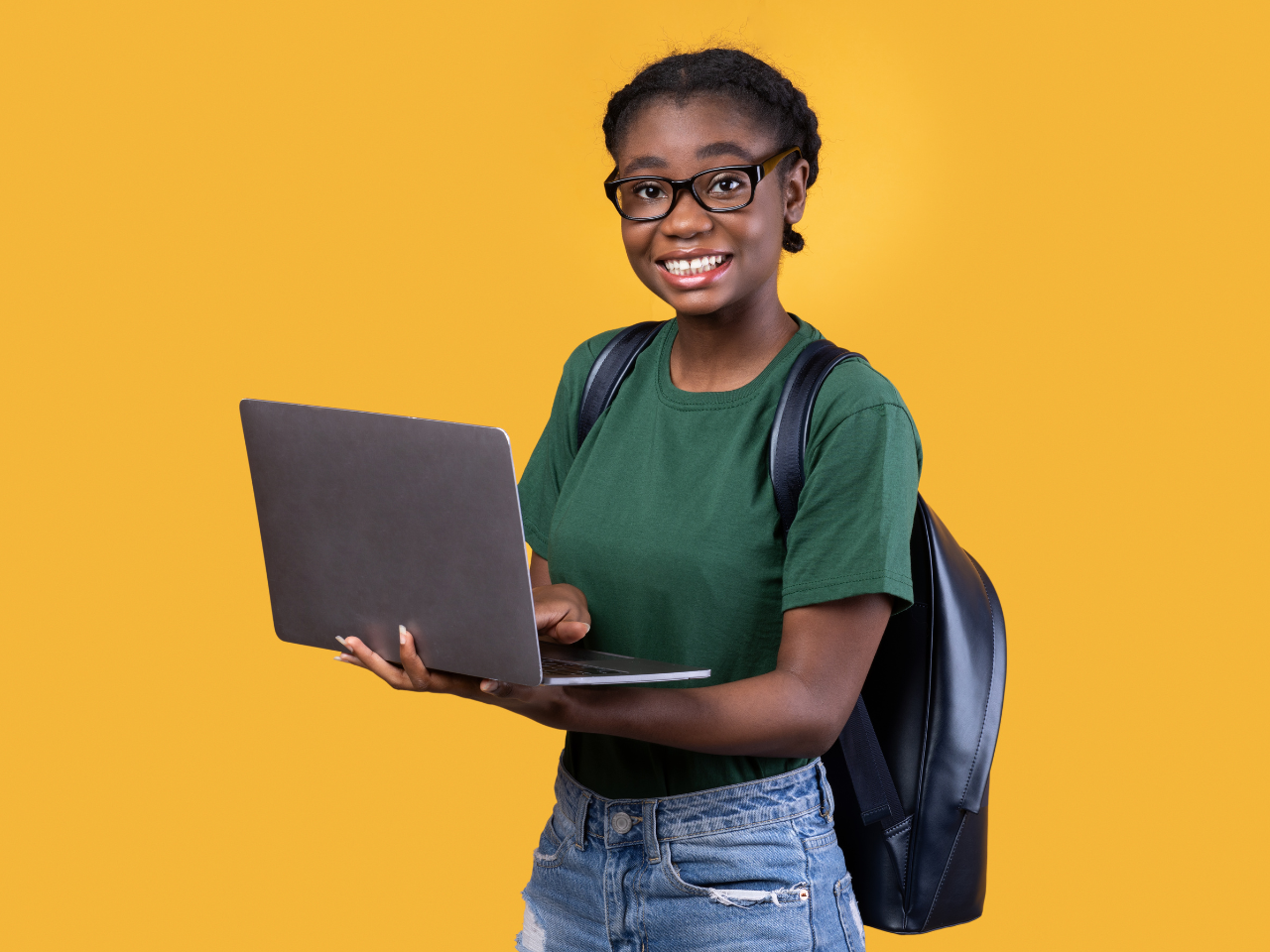 girl with laptop in her hands and backpack on.