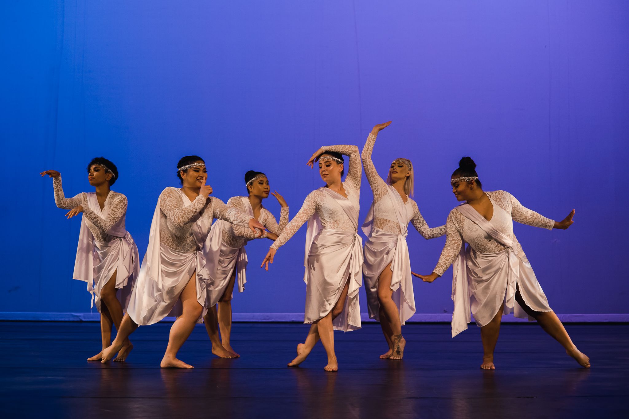 Three dancers leaping in the air