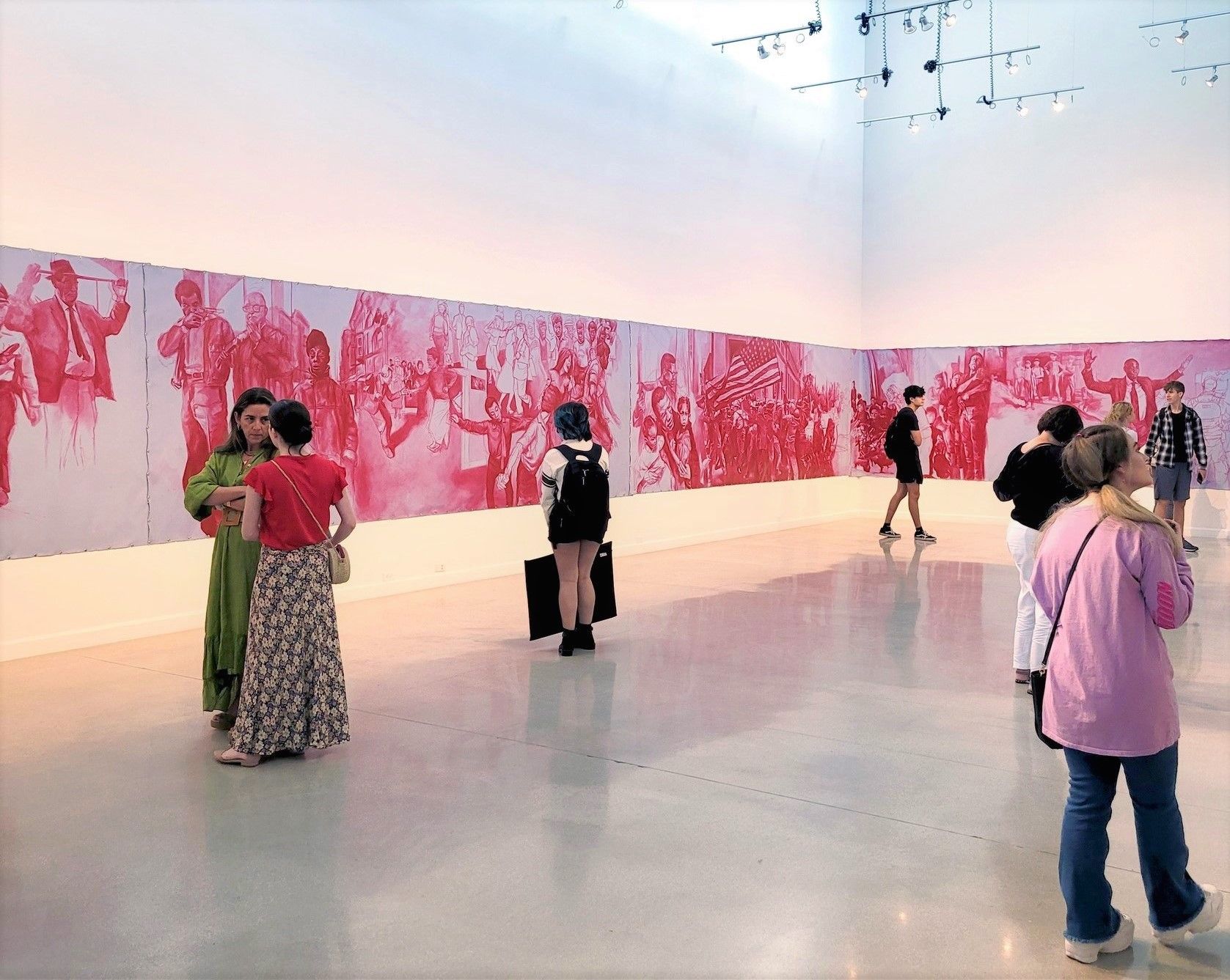 Attendees looking at an art exhibit